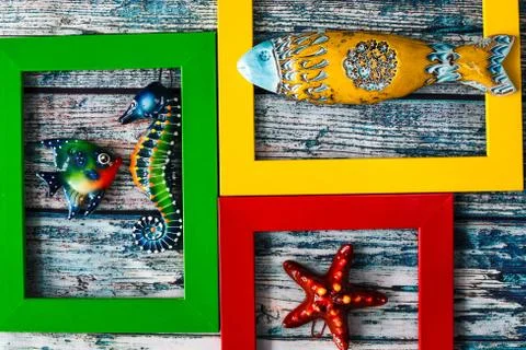 Marine theme - ceramic fish in multi-colored frames Stock Photos