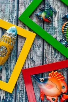 Marine theme - ceramic fish in multi-colored frames Stock Photos
