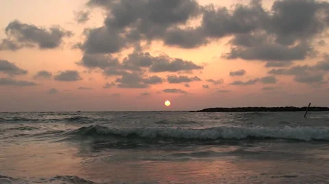 Marine waves on a background sunset of a sun in city Tel Aviv Stock Footage 39652298