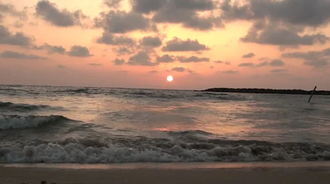 Marine waves on a background sunset of a sun in city Tel Aviv Stock Footage 39652301