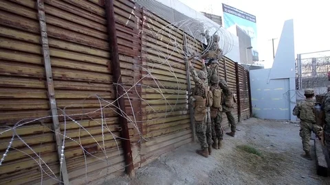 Marines attach razor wire to Mexican border wall at San Ysidro Port of Entry Stock Footage 98185985