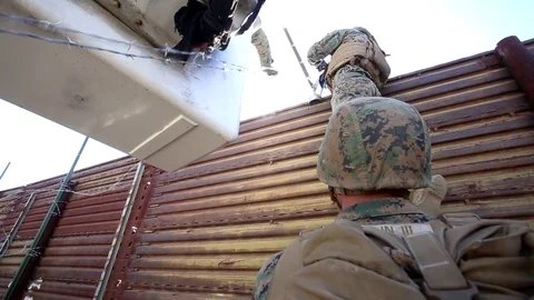 Marines attach razor wire to Mexican border wall at San Ysidro Port of Entry Stock Footage 98186031