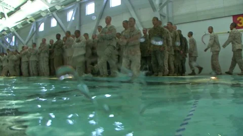 Marines in basic training learn swimming and aquatic rescue skills. Video stock 123373755