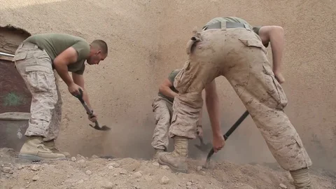 Marines digging with shovel at small combat outpost in Musa Qal'eh - 2010 動画素材 107551508