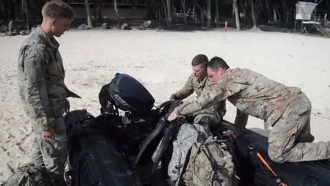Marines loading inflatable craft with backpacks  Video stock 82934395