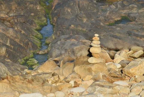 Mariola on the rocks of a beach Stock Photos