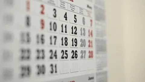 Mark the date in wall calendar with blue marker Stock Footage 70961954