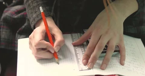 Mark dots with a pencil in a grid notebook to connect them with a ruler. Mat Stock Footage 335782237