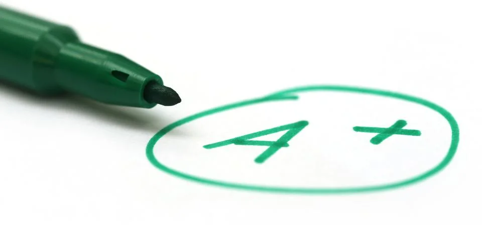 Mark a+ with a pen Stock Photos