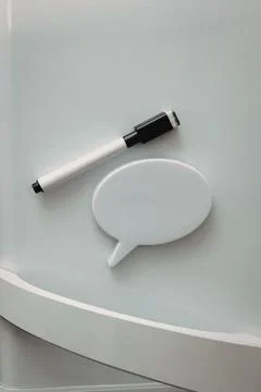 Marker pen and speech bubble on round white surface Stock Photos