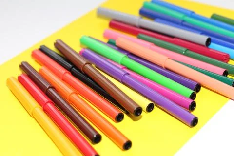 Markers are scattered on the table Stock Photos