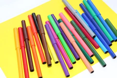 Markers are scattered on the table Stock Photos