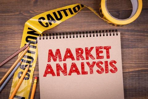 Market Analysis. Yellow warning tape and notebook on wooden background Stock Photos