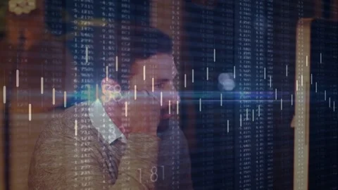Market data sparking animated chart overlay across frame while trader monitoring Video stock 334112635