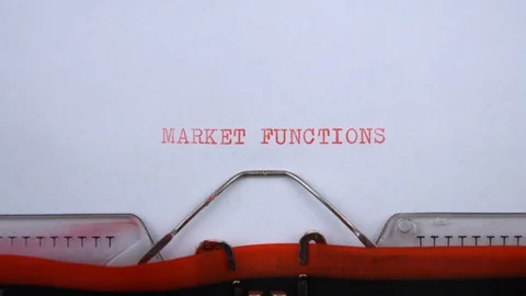 Market functions - phrase printed on an old typewriter in red letters, close up. Stock Footage 129535059