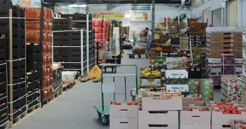 Market place organic boxes fresh fruits wholesale store. Defocused supermarket Stock Footage