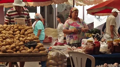 A market trader finding a safe place to hide her takings. Stock Footage 65393963