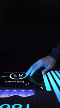 Marketer in dark clothing touching interactive digital screen with glowing blue Stock Photos
