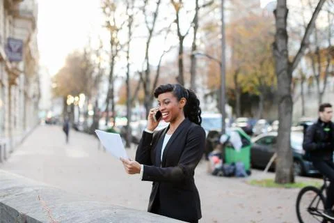 Marketer got raise, pretty lady standing on street with papers i 스톡 사진