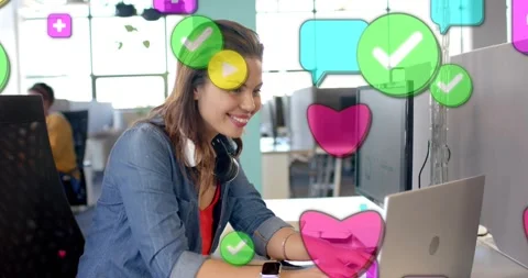 Marketer typing on laptop in office, generating social icons growing across Stock Footage 330955266