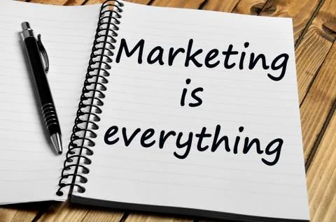 Marketing is everything words on notebook Stock Photos