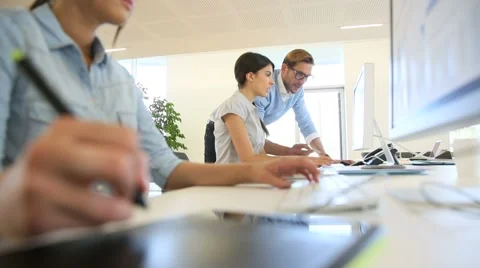 Marketing people in office, worker using graphic tablet in foreground Stock-Footage 51259166