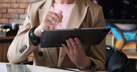 Marketing professional focused on tablet, analyzing audience insights and market Stock Footage 276472432