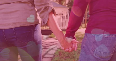Marketing showing couple walking path turning wrists to clasp hands adding heart 스톡 동영상 311501043