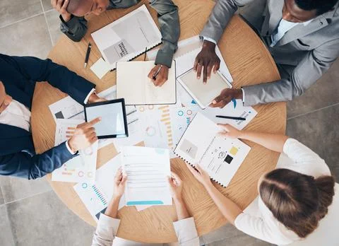 Marketing team with data documents and technology working on a project with Stock Photos