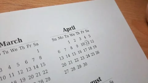 Marking April 11 date on the calendar Stock Footage 303991899