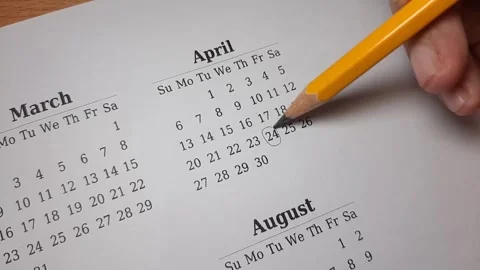 Marking april date on the calendar Stock Footage 296143625
