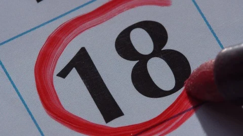Marking the date in the calendar with a red marker Stock Footage 99295476