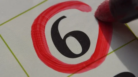 Marking the date in the calendar with a red marker Stock Footage 99296474