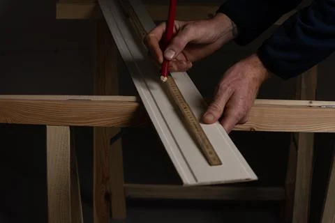 Marking decorative wall panel board with pencil and folding ruler before cu.. Stock Photos