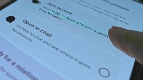 Marking the intention as Here to date on Dating app Stock Footage 304579422