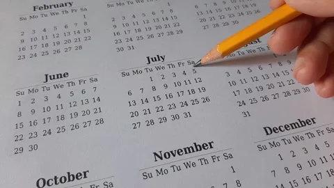 Marking July date on the calendar Stock Footage 311436422