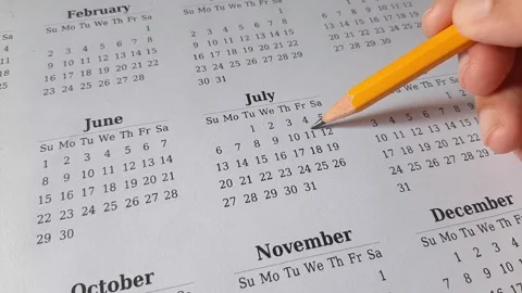 Marking July date on the calendar Stock Footage 311437088