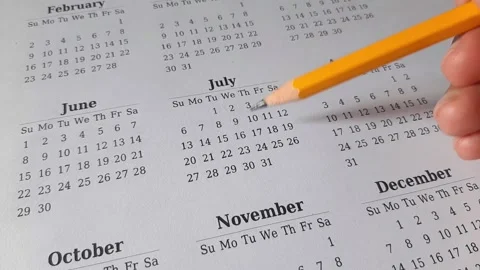 Marking July date on the calendar Stock Footage 311437090