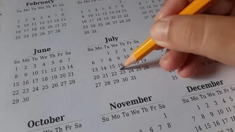 Marking July date on the calendar Stock Footage 311438750
