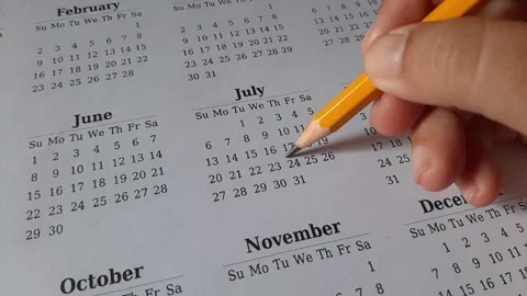 Marking July date on the calendar Stock Footage 311438858