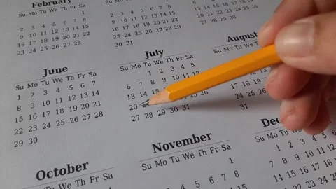 Marking July date on the calendar Stock Footage 311439471
