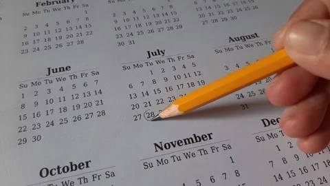 Marking July date on the calendar Stock Footage 311439480