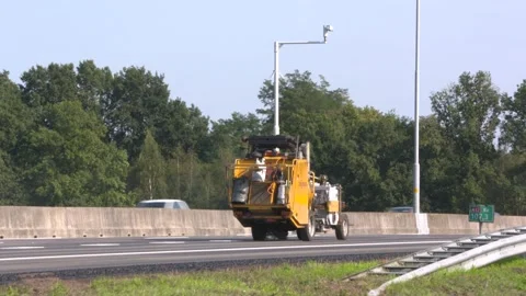 Marking machine slowly moves across the asphalt applying road markings Stock Footage 139821564