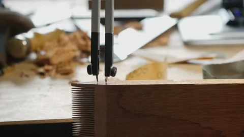 Marking a piece of wood with a compass. making a wooden beard comb Stock Footage 156670180