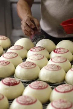 Marking red notes on chinese dumpling before baking Stock Photos
