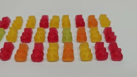 Marmalade bears are arranged in lines and grouped by color in this fun display Stock Footage 339592801