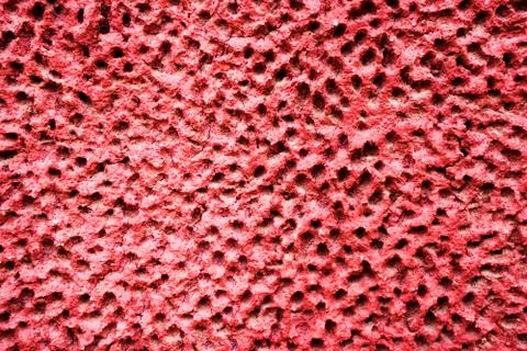 The maroon dilapidated cement wall texture. Dark pink stucco background. Abst Stock Photos