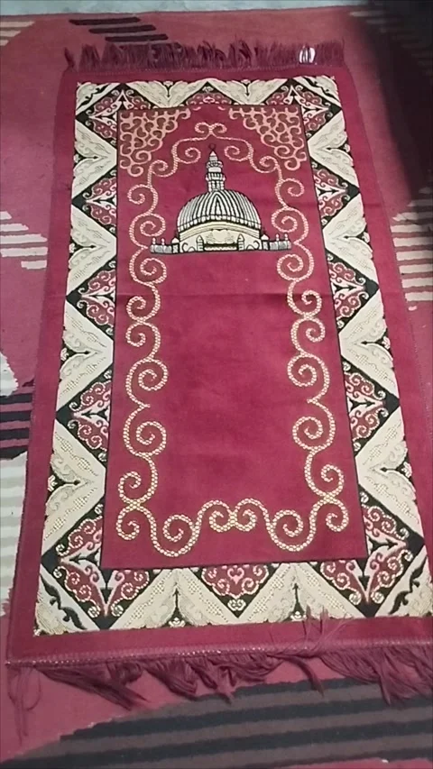 The maroon prayer mat is very nice Stock Footage 293056437