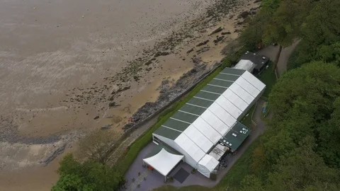 Marquee looking over beach at low tide, people on the beach, drone aerial 4K Stock Footage 101118438