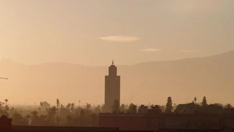 Marrakech Minaret and Rooftops in Soft Morning Light with Rooftop and Palm Tree Video stock 300541759